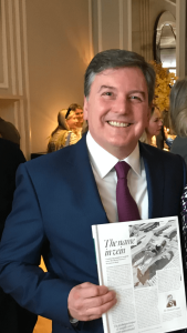 Mr Michael Gaunt holding a copy of Tatler magazine